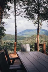 The result is a modern rustic retreat allowing visitors to ascend gradually into the canopy and, once there, enjoy stunning mountain views from among the trees. 
