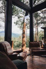 The result is a modern rustic retreat allowing visitors to ascend gradually into the canopy and, once there, enjoy stunning mountain views from among the trees. 

