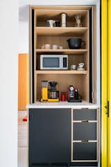 The beverage station, complete with a paneled undercounter fridge and pocket doors to hide the mess. Photo by Sarah Shields 