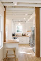 The kitchen expanded by sacrificing a portion of the third bedroom. What footprint remained was claimed for a home office. 
