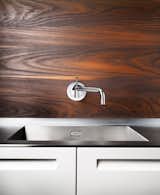 a wall mounted articulating kitchen faucet - why don't we see this all the time? no more lever handles hitting the backsplash on a tight install, and no more cleaning up goo from around the base of a deck mounted kitchen faucet 