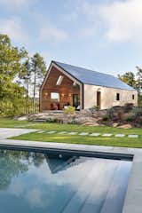parapets on the rake edge & peak of the roof, and hidden gutter make this 16KW solar array look like the roof surface itself