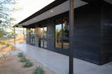 Curb appeal showcasing Shou Sugi ban siding and standing seam metal roof