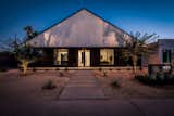 Modern curb appeal with desert landscape, smoothed stucco, Shou Sugi ban siding and standing seam metal roof