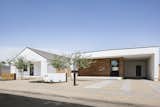 Modern exterior architecture featuring a store-front commercial front door, white stucco and wood paneling