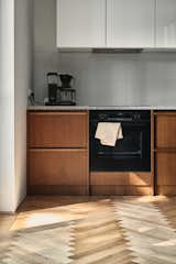 Kitchen, Wood Cabinet, Wood Counter, White Cabinet, Medium Hardwood Floor, and Ceramic Tile Backsplashe Kitchen  Photo 5 of 20 in Apartment in a modernist building from the 1950s by Michal Martynowski