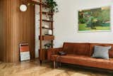 Living Room, Sofa, Sectional, Medium Hardwood Floor, Ceiling Lighting, and Bookcase Living room  Photo 7 of 20 in Apartment in a modernist building from the 1950s by Michal Martynowski