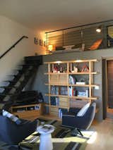 After: added a stairs, railings and created a upstairs "lounge area" and a place for guests to crash for the night. Shelving by Ikea, Swivel chairs and side table by West Elm