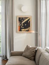 Sofa, Flexform; floor lamp, Gubi; Picture on the wall "Composition" by Pierre Gasteau, 1950s, AlinaPinsky Gallery.  