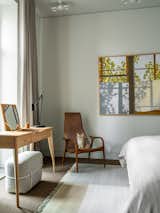 Pouf, Ligne Roset; table lamp, Kalmar; panel by Rashid Dominov, Alina Pinsky Gallery.