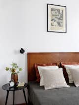 Bed designed by Blockstudio. Cover, Zara Home. Colorful pillows, Crate and Barrel, pillows plain — H&M Home. Wall lamp, Marset. Bedside table, Kartell.