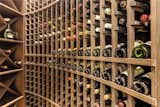 Storage Room Boasting capacity of approximately 568 bottles, even the most enthusiastic oenophiles will be perfectly happy with the abundance of storage for a few 750mL containers of their favorite fermented grapes.  Photo 8 of 17 in Parking for 12 and a 500+ bottle wine cellar, $2.8M Custom Houston Home is  Post-Pandemic Party Perfection by David Brent Atkins