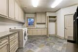 Situated on the second floor is this huge 16' x 15' laundry room that features an abundance of stone counters with a utility sink to the right of the window. An additional walk-in storage closet can be found behind the door to the right of the drip-rod for hanging 'delicates'.