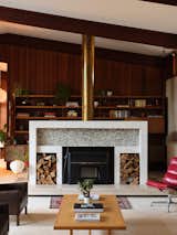 Another look at the fireplace with its brass chimney cover and floating marble hearth.