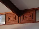 Decorative molding flanks both sides of each beam in the living area.