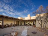 The home was designed around a courtyard that provides a more intimate outside setting from the vast open range.  Photo 5 of 13 in Armendaris Ranch by FPC Architects & Planners