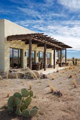 To keep the design concept, the lodge maintains one story with low roof lines and derives the exterior palette from the surrounding environment.  Photo 3 of 13 in Armendaris Ranch by FPC Architects & Planners