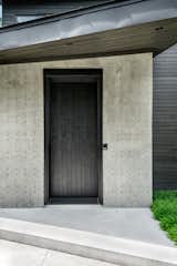 Clean sho-sugi-ban-inspired door with no exterior hardware...