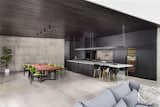 Open living - 18' concrete top island, 12' locally sourced walnut dining table above which is sho sugi ban ceilings