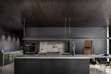 Sleek kitchen with a poured concrete backsplash