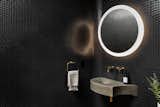 Curved corners in the powder room and custom-designed concrete sink