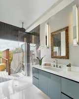 Bath Room, Pedestal Sink, Ceramic Tile Floor, Pendant Lighting, and Marble Counter  Photo 9 of 13 in We Raised the Roof for this Sun-Splashed, Playful Renovation by Levy Art + Architecture