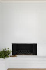 Living Room, Medium Hardwood Floor, Gas Burning Fireplace, and Corner Fireplace White painted brick fire place.  Photo 10 of 57 in Cottingham Home by Tommy Daspit