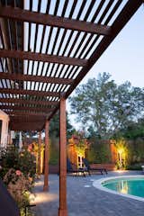 Outdoor, Shrubs, Back Yard, Hardscapes, Trees, Gardens, Garden, Pavers Patio, Porch, Deck, Small Patio, Porch, Deck, Small Pools, Tubs, Shower, and Landscape Lighting A new wood pergola provides shade to the house.  Photo 3 of 8 in Modern Suburban Backyard by Secret Garden Landscapes