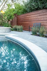 Outdoor, Back Yard, Small Pools, Tubs, Shower, Flowers, Shrubs, Hardscapes, Trees, Grass, Walkways, Gardens, Small Patio, Porch, Deck, Garden, Pavers Patio, Porch, Deck, Landscape Lighting, and Horizontal Fences, Wall Cohesion of materials.  Photo 6 of 8 in Modern Suburban Backyard by Secret Garden Landscapes