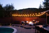 Outdoor, Back Yard, Small Pools, Tubs, Shower, Garden, Gardens, Hardscapes, Horizontal Fences, Wall, Decking Patio, Porch, Deck, Small Patio, Porch, Deck, Hanging Lighting, and Pavers Patio, Porch, Deck Nighttime Ambiance   Photo 5 of 8 in Modern Suburban Backyard by Secret Garden Landscapes