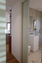 Bath Room, Pedestal Sink, Stone Slab Wall, Full Shower, Two Piece Toilet, Corner Shower, Open Shower, and Ceiling Lighting bathroom   Photo 11 of 25 in Coastal Home Grado by Architect & Friends