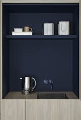 The character of the home is defined by its crisp minimalist lines, such as in this kitchen sink area hidden behind one of the cabinet doors.