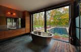 Master bathroom to the pool with autumnal trees.