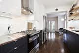 Smirle kitchen - stainless steel counter top, integrated task lighting, diningroom pass-thru