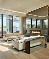 Contemporary  living room custom fireplace and direct views to waterway.