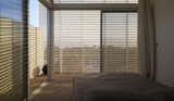 The facade is defined by a series of metal doors of high 12 feet. 