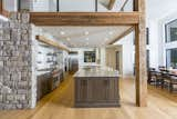 Kitchen, Engineered Quartz Counter, Wood Cabinet, Stone Counter, White Cabinet, Undermount Sink, Wall Oven, Light Hardwood Floor, Range Hood, Stone Slab Backsplashe, Refrigerator, Microwave, Range, and Ceiling Lighting Kitchen and Loft  Photo 4 of 7 in The Wood Residence and Office by Wood Architects