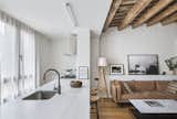 Kitchen, Light Hardwood Floor, Marble Counter, Ceiling Lighting, Marble Backsplashe, Cooktops, and Undermount Sink kitchen and living room  Photo 11 of 13 in Can Albert by Domuslabs