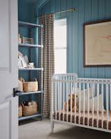 Kids Room, Bookcase, Storage, Bed, Bedroom Room Type, Playroom Room Type, Boy Gender, Neutral Gender, Toddler Age, and Shelves A peak into the nursery and the sweet jenny lind crib.   Photo 4 of 7 in Beach Charm Nursery by Sayler Studio