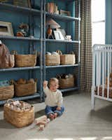 Kids Room, Bedroom Room Type, Storage, Toddler Age, Neutral Gender, Boy Gender, Bed, Shelves, and Bookcase Marty sits on the floor of his nursery, playing with his blocks.    Photo 1 of 7 in Beach Charm Nursery by Sayler Studio