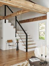 A new modern wood and steel handrail -using the existing posts. Open framing above from the original structure.