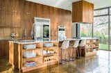 Kitchen, Quartzite Counter, Ice Maker, Range, Cooktops, Microwave, Recessed Lighting, Undermount Sink, Range Hood, Wood Cabinet, Wall Oven, Refrigerator, Dishwasher, and Concrete Floor  Photo 5 of 8 in Bringing The Outside In by Jeannette Mock