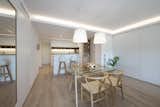 Dining Room, Pendant Lighting, Medium Hardwood Floor, Ceiling Lighting, Table, Chair, Storage, and Track Lighting  Photo 9 of 20 in A homely and modern flat with Nordic charm by Sincro