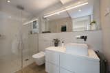 Bath Room, Engineered Quartz Counter, Vessel Sink, Enclosed Shower, Recessed Lighting, Porcelain Tile Floor, Porcelain Tile Wall, and One Piece Toilet  Photo 17 of 20 in A homely and modern flat with Nordic charm by Sincro