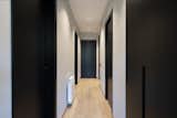 Hallway and Medium Hardwood Floor  Photo 13 of 27 in An elegant flat where dark tones predominate by Sincro