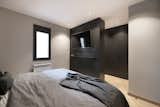 Bedroom, Wardrobe, Medium Hardwood Floor, Shelves, Dresser, and Recessed Lighting  Photo 20 of 27 in An elegant flat where dark tones predominate by Sincro