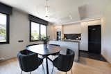 Dining Room, Chair, Pendant Lighting, Medium Hardwood Floor, and Table  Photo 5 of 27 in An elegant flat where dark tones predominate by Sincro