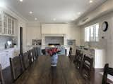 The white kitchen finishes are brought to life with the dark timber flooring and grand dining table. the colour contrast is shown through the black features implemented in this area. The attention to detail is shown in every corner of this open kitchen 