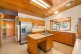 Kitchen, Wood Cabinet, Refrigerator, Granite Counter, Wall Oven, Laminate Counter, Terrazzo Floor, Dishwasher, Ceiling Lighting, Drop In Sink, and Cooktops Kitchen  Photo 12 of 51 in The Wallmark House by Moritz Kundig by Alice M Galeotti WA RE Lic 21106