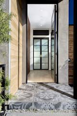 The entry closet doors mimic the front door glass panes and the subtle grey pattern tiles add some dimension